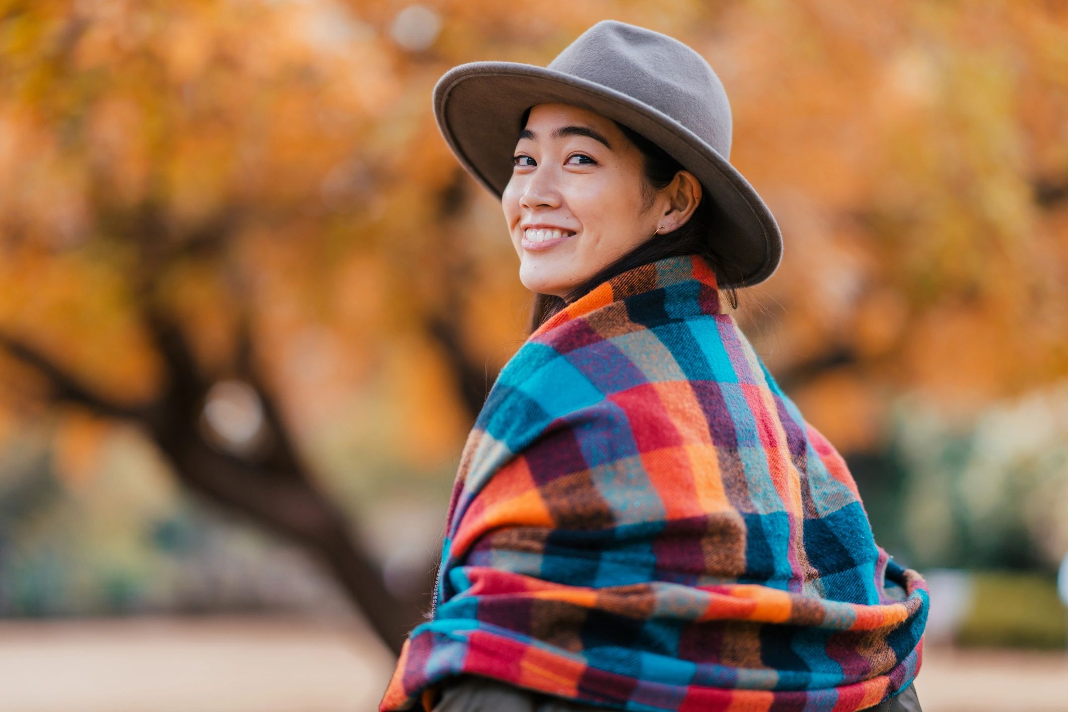 Fashionable woman wearing a soft scarf outdoors