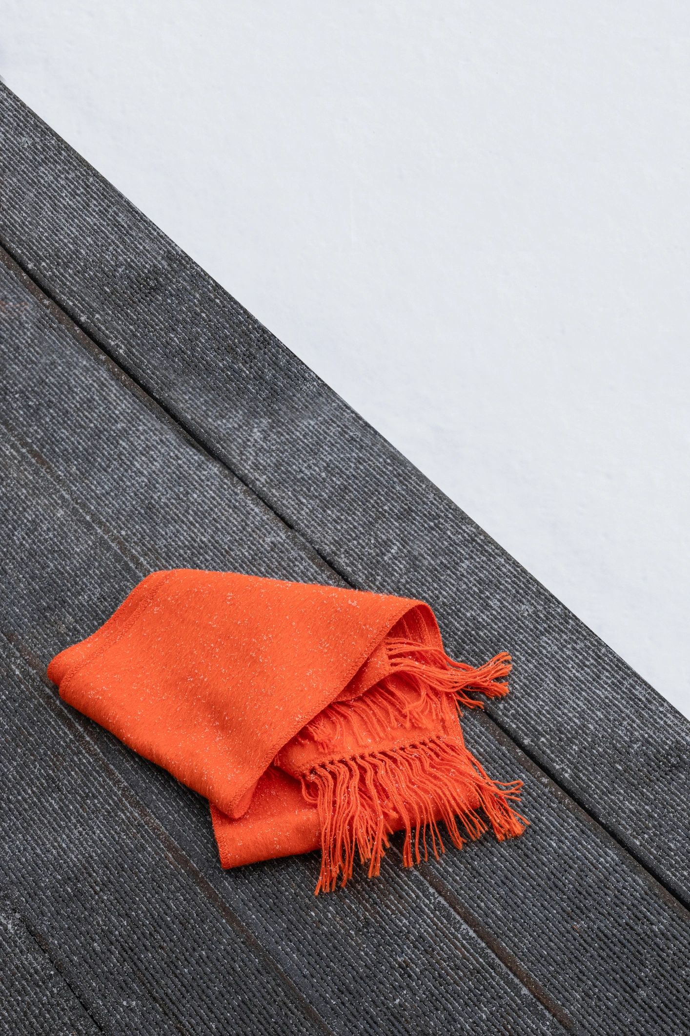 Orange scarf styled on a wooden bench